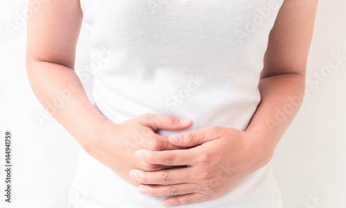 Closeup woman stomach ache with white background, health care and medical concept