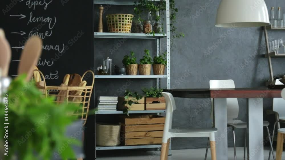 Industrial style home interior with wooden communal table and chairs