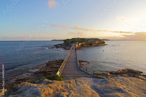 A view of bridge towards Bare Island, La Perouse, Sydney during golden hour before sunset. photo
