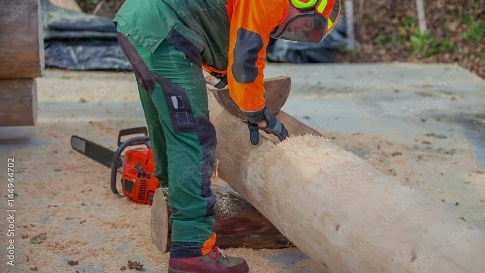 A young forester is checking if something fits in the tree trunk. He has just made a big hole inside the tree trunk.
A young forester is checking if something fits in the tree trunk. He has just made a big hole inside the tree trunk.
