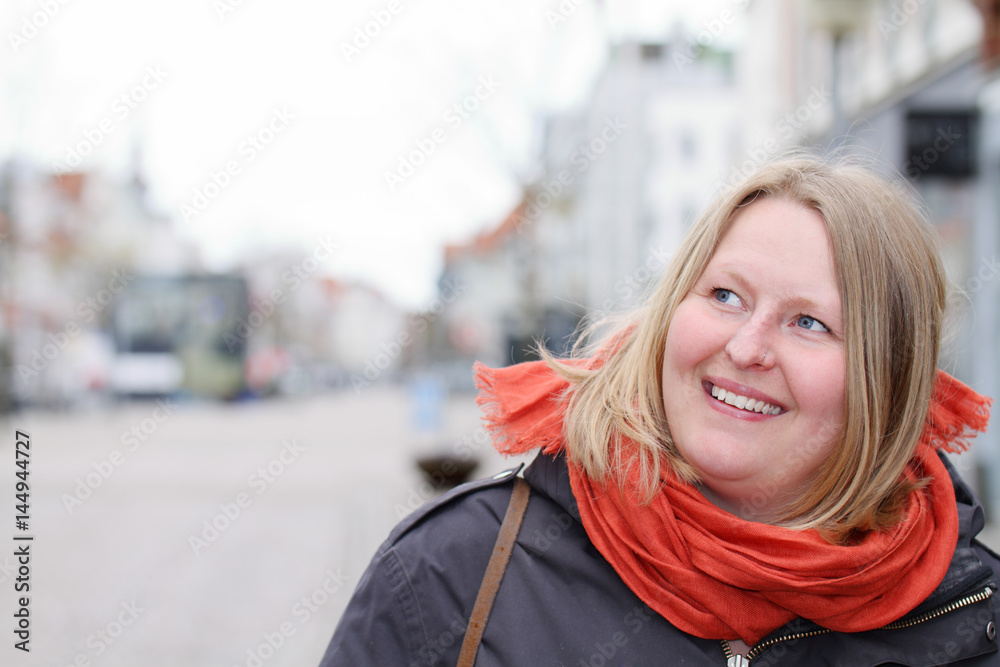 Scandinavian woman looking at copyspace in town