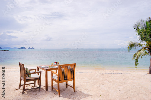 Table setting. Resort cafe on the tropical sea beach with beautiful view. © luengo_ua
