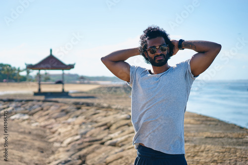 Handsome and confident. Outdoor portrait of happy young african man on the beach.