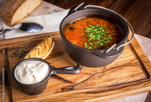 Fresh soup Solyanka with lemon and sour cream photo