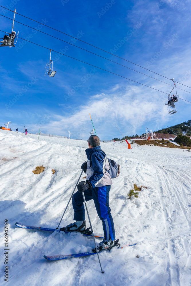 Old man skier skiing on ski resort in winter, Ax-les-Thermes, France