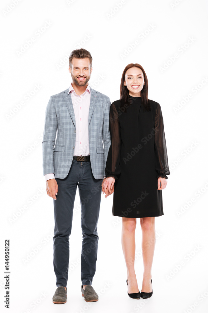 Happy young loving couple standing isolated Happy young loving couple standing isolated