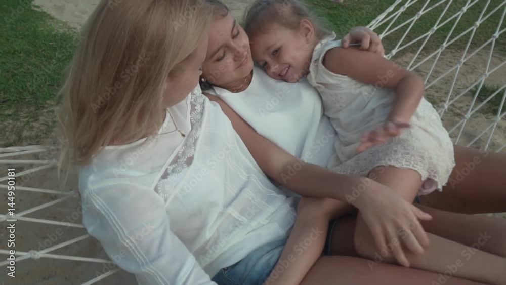 Happy family rides emotionally on hammock slow motion stock footage video Happy family rides emotionally on hammock slow motion stock footage video