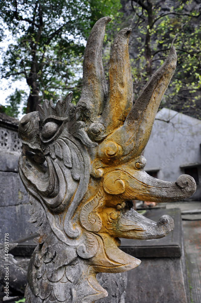 Antique carving in stone with mythical motif. Bich Dong pagoda, Vietnam