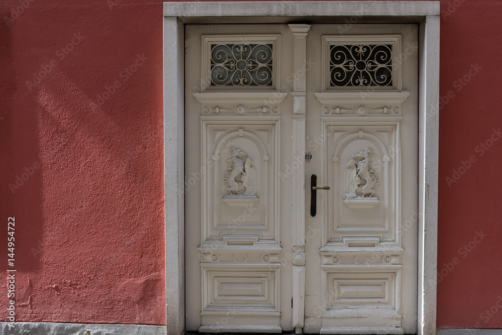 An carved Door in a red Wall An carved Door in a red Wall