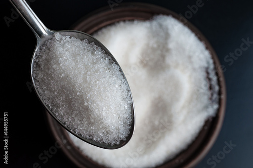 a spoon full of white sugar