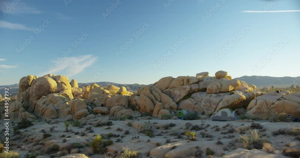 Tourist camping with large rock formations at Joshua Tree National Park.