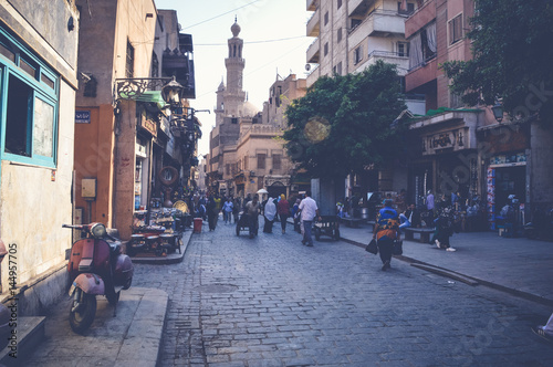 cairo, egypt, april 15, 2017: people walking in muizz street photo