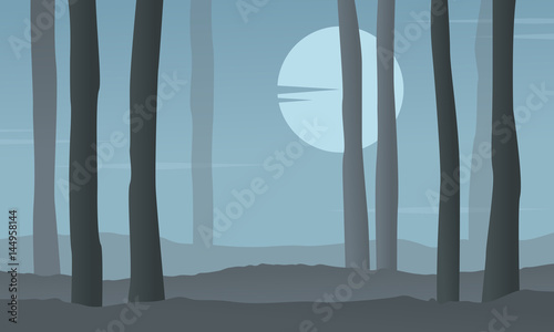 Silhouette of forest at night with moon