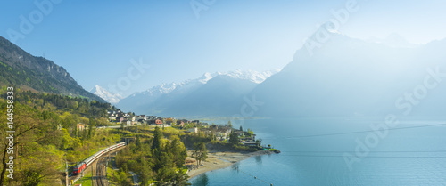 Small towns in Europe. Fluelen. Switzerland. View of the small town in the Alps mountains. Traditional houses. Railway along Lake Lucerne. Canton  Uri.