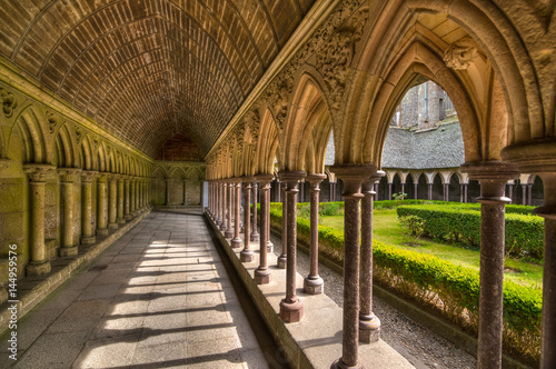 Inner yard garden surrounded by archade corridor of Saint-Michel abbey, France photo