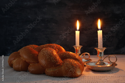 shabbat image. challah bread, shabbat wine and candles photo