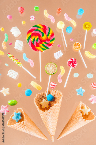 Close-up top view of crispy waffle cones and mix of colorful sweet candies