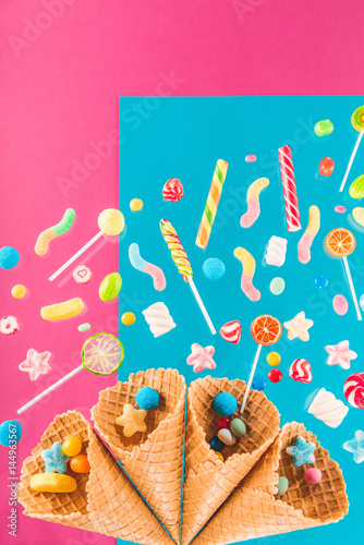 Close-up top view of waffle cones and mix of delicious candies
