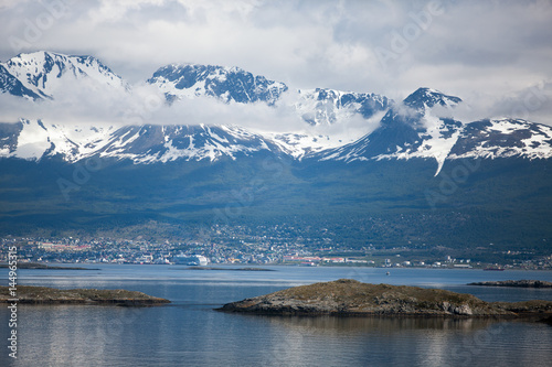 Tierra del Fuego, landscape of snowy and wooded mountains and ocean