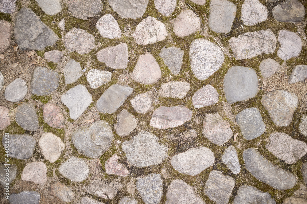 Old cobbled stone pavement of cobblestones in the city. Top view. Old cobbled stone pavement of cobblestones in the city. Top view.