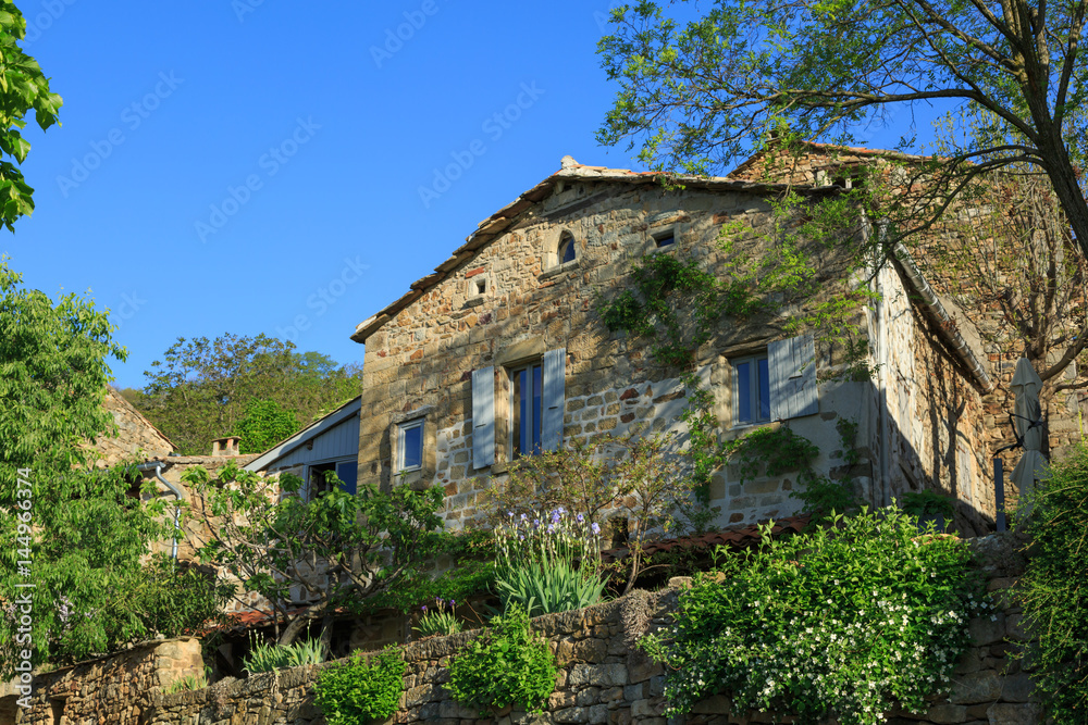 Garden and an old maison (house) in the the Ardeche, France, during spring.