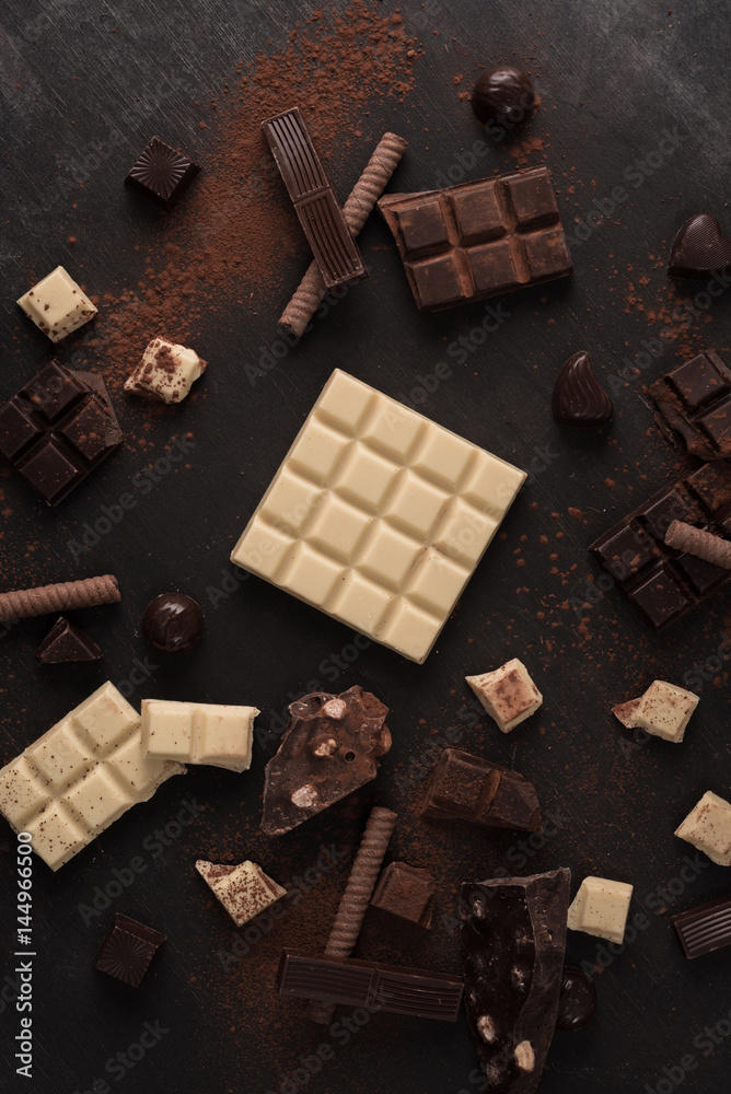 Big variety of chocolate bars crashed into pieces Big variety of chocolate bars crashed into pieces