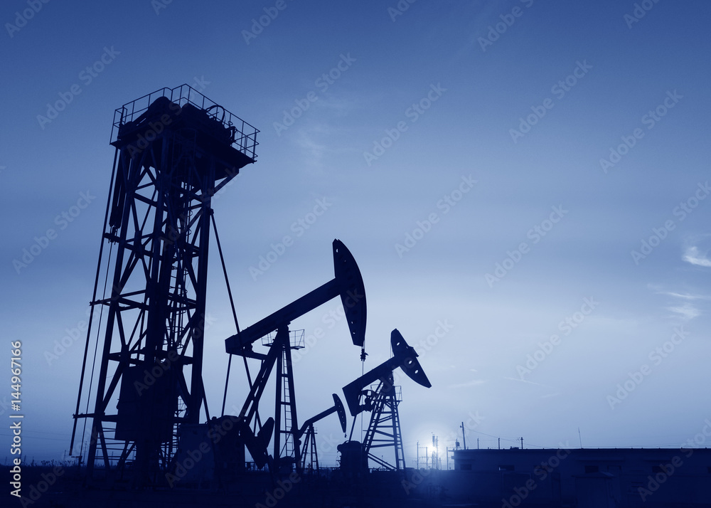 Pumping unit is working in oil field of the sunset Pumping unit is working in oil field of the sunset