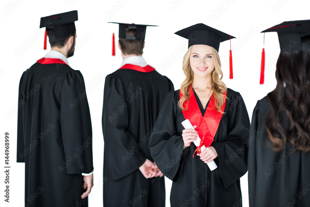 attractive student in graduation cap with diploma, with friends behind isolated on white attractive student in graduation cap with diploma, with friends behind isolated on white