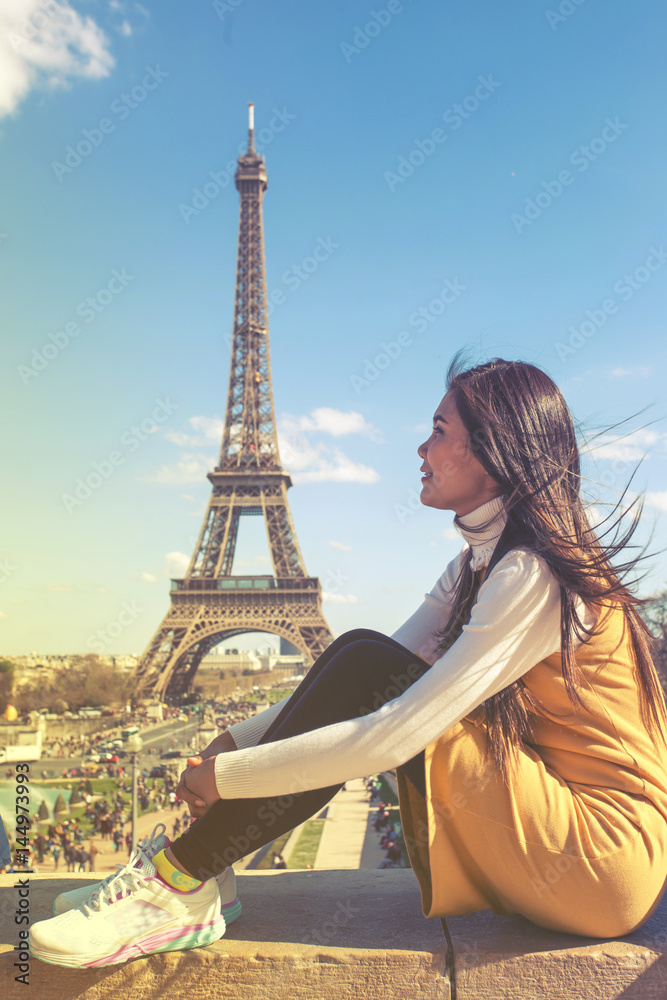 Woman touris tat the Eiffel tower in Paris, Famous popular touristic place in the world.