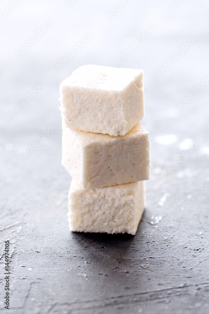 Pile of marshmallow cubes Vertical photo Pile of marshmallow cubes Vertical photo