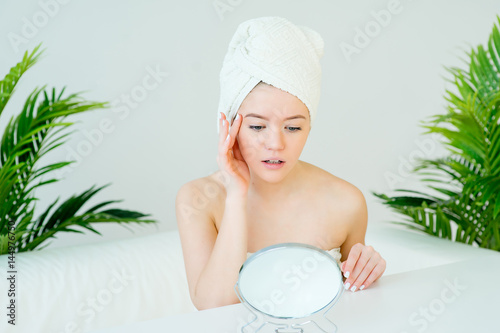 Young woman looking in mirror