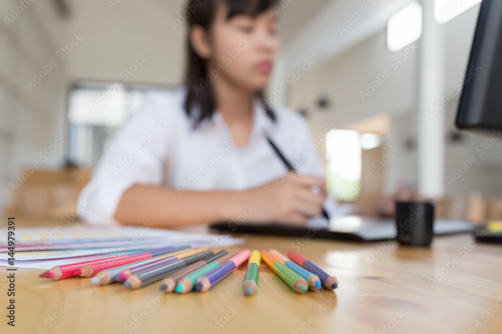 freelance graphic designer drawing on digital tablet. woman working with color swatch catalog samples for selection - Creativity Editor Ideas Concept freelance graphic designer drawing on digital tablet. woman working with color swatch catalog samples for selection - Creativity Editor Ideas Concept