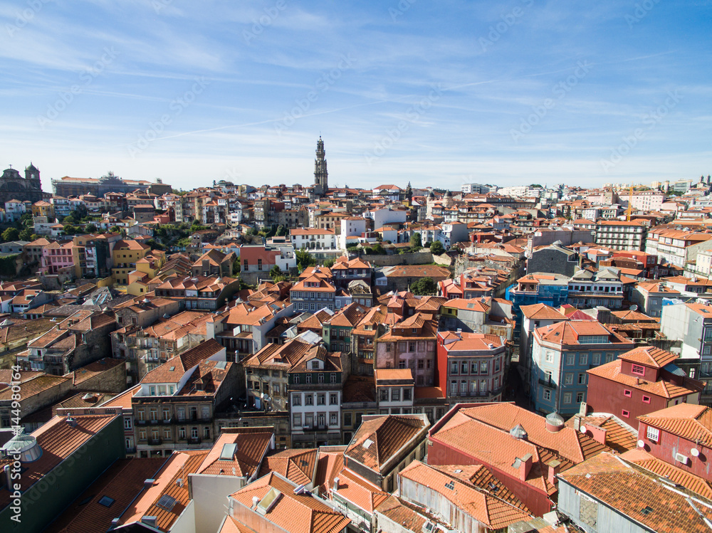Aerial view of orange rooftops and historical buildings of the old city and Clerigos church tower of Porto, Portugal