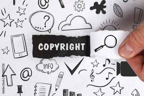 Business, Technology, Internet and network concept. Young businessman shows the word: Copyright photo