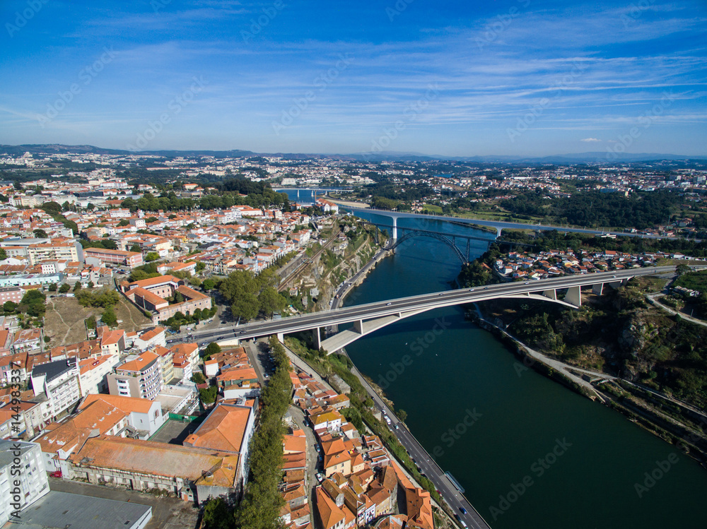 Panoramic view of the old city of Porto. One flew over the roofs of the houses, a river and a bridge.