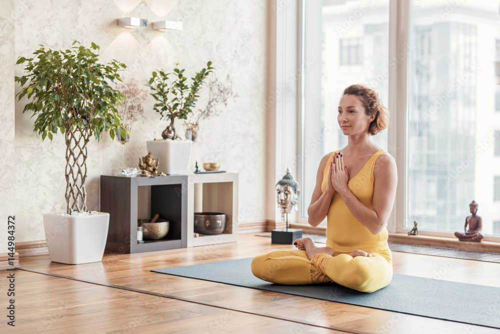 Calm girl relaxing during yoga Calm girl relaxing during yoga