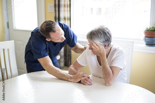 Senior woman with the caregiver at home