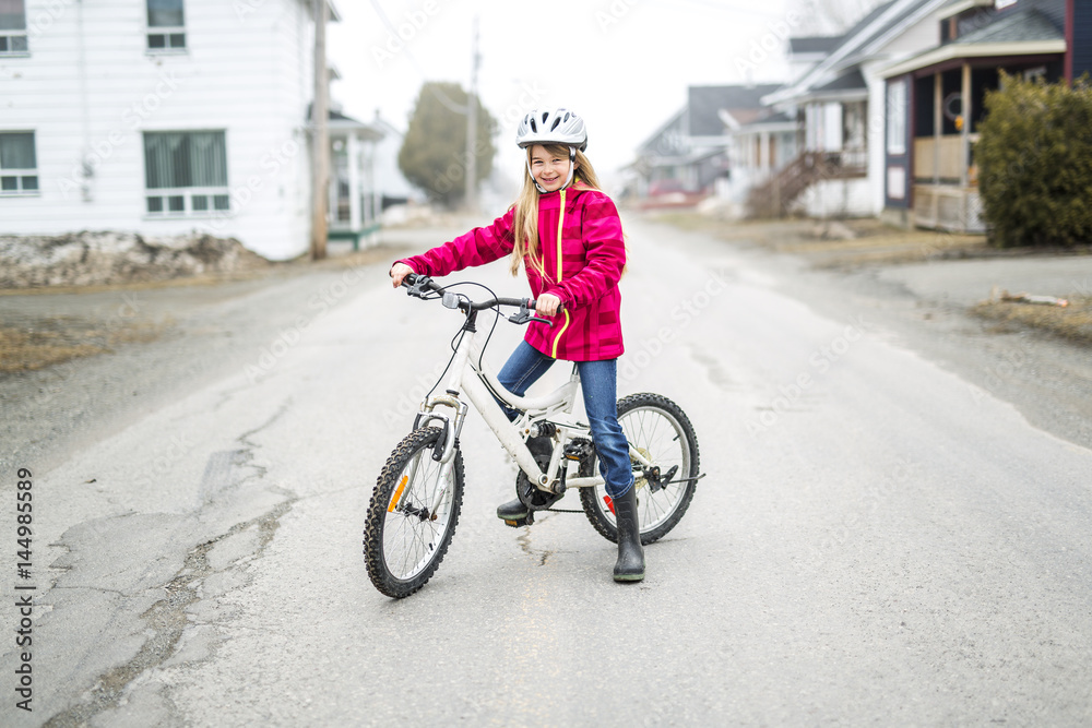 Little girl riding a bike in a city Little girl riding a bike in a city