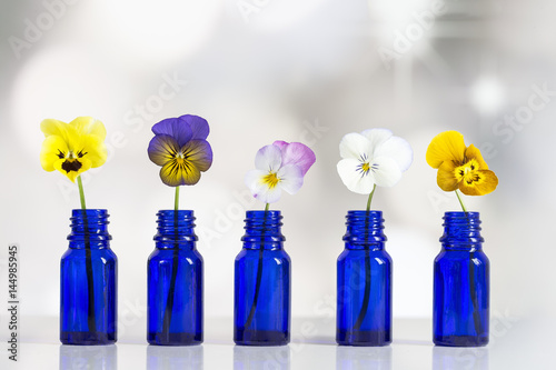 nice pansies,essential oil in glass bottle photo