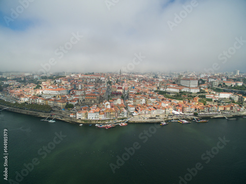 Panoramic view of the old city of Porto. One flew over the roofs of the houses, a river and a bridge.