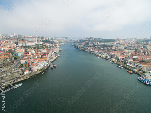Panoramic view of the old city of Porto. One flew over the roofs of the houses  a river and a bridge.