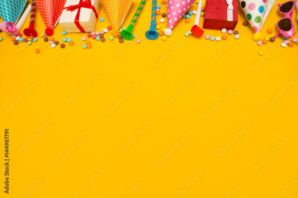 children party background. birthday background. Colorful party frame with  cap and whistle on yellow background Stock Photo | Adobe Stock
