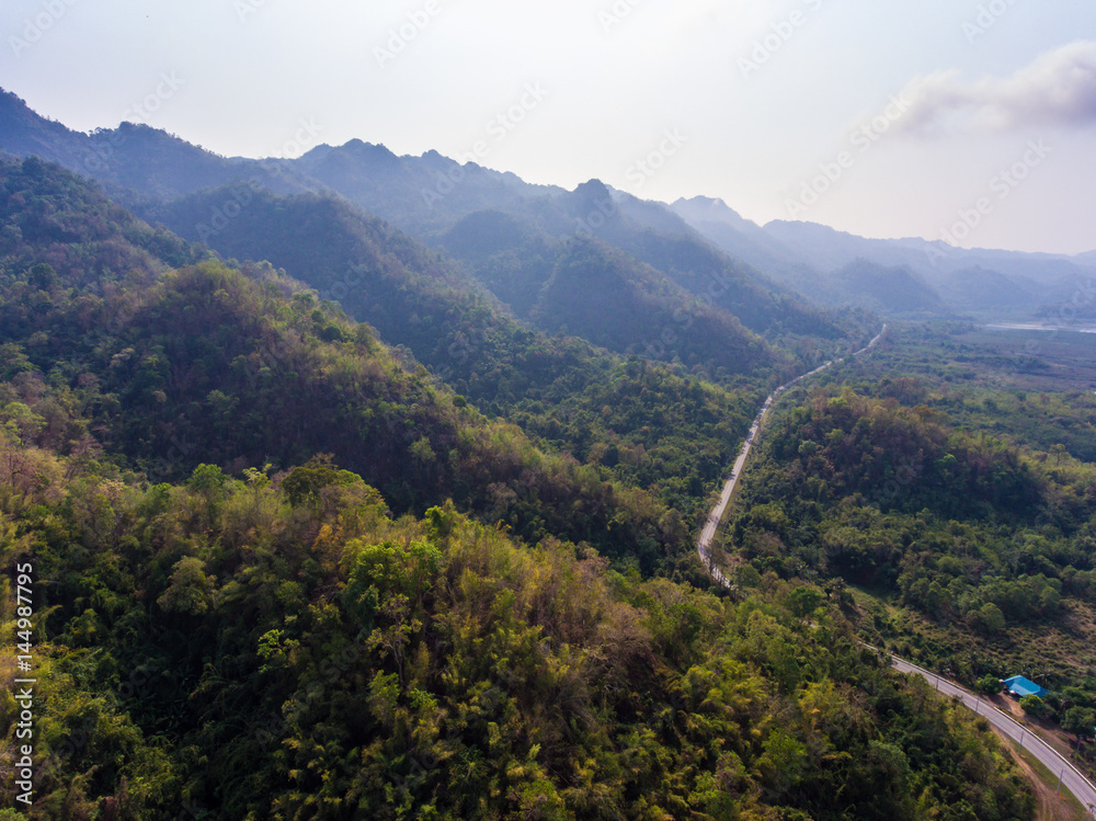 Aerial shot of  highway to the mountains.