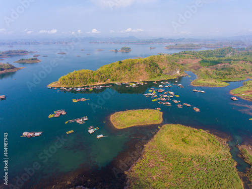 Aerial view of Village and fish farm among lake and mountain.