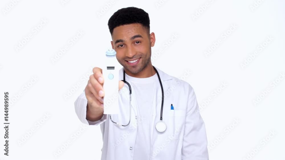 Closeup of temperature measuring device in hand of african young doctor