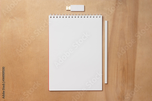 Notebook with a pencil and usb memory stick. Notepad with blank white sheets