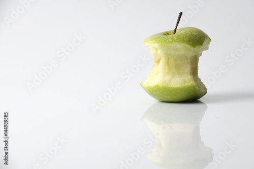 Apple bite from a ripe green apple isolated on white