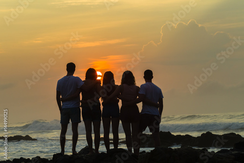 Girls Boys Friends Silhouetted Beach Ocean Sunrise Scenic Rocky Coastline