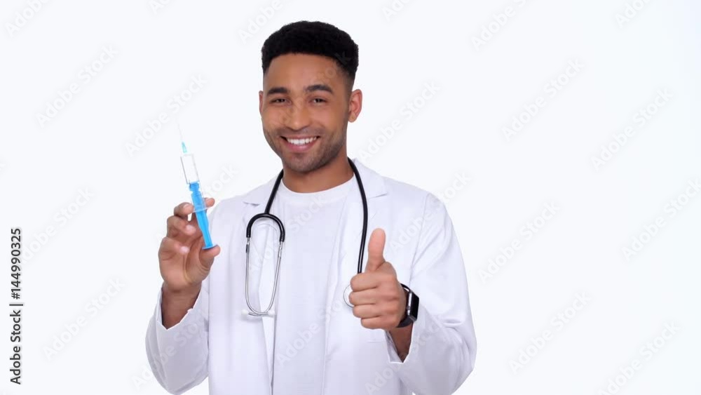 Young doctor showing syringe and gesture okay isolated Young doctor showing syringe and gesture okay isolated
