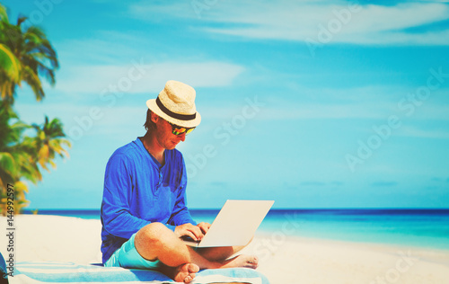 man with laptop on tropical beach © nadezhda1906